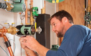 PUMP IT UP: Jeff Tardif, job site supervisor for Jim Godbout Plumbing, Heating & Air Conditioning in Biddeford, Maine, wires a Taco VT2218 circulator as he completes a hydronic installation at a home in Kennebunk, Maine. Chosen by Tardif for the job, the VT2218 is a high-efficiency, electronically commutated motor (ECM) delta-T circulator that provides up to 22 feet shut-off head and 18 gallons per minute (gpm), maximum flow, covering a broad range of applications. Photo courtesy of Taco Inc.